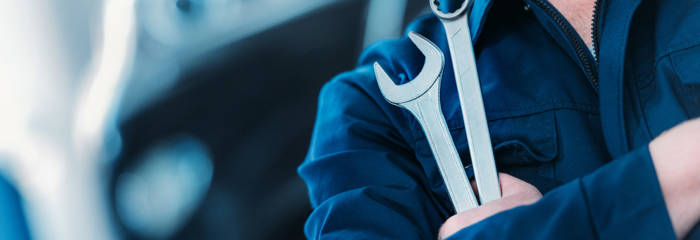 mechanic close up holding wrench and spanner